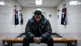 African-American man sitting alone on a locker room bench with head bowed, empty NBA locker room, dimly lit, mental health and athlete depression concept