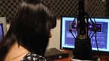 Estúdio de rádio com microfone e mesa de trabalho