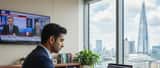 British solicitor reviewing media law documents in a London office with news playing in the background
