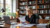 Literary agent reviewing a TV adaptation contract in a London office with bookshelves in background