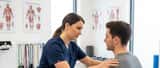 Sports medicine doctor examining a patient's shoulder in a Liverpool clinic ahead of the Grand National 2026