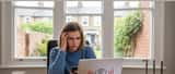 British person frustrated with broadband outage checking router at home desk