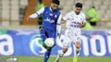Iranian footballers competing in a league match, illustrating the athlete-wealth story