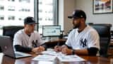 Yovanny Cruz Yankees pitcher meeting financial advisor with baseball glove and contract documents