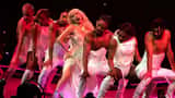 Lady Gaga performing at the Mayhem Ball tour, dramatic stage lighting