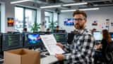 Software developer reading a termination letter in a gaming studio office