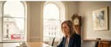 Female solicitor reviewing legal documents in a bright meeting room