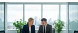 Employment lawyer reviewing dismissal contract with client in a bright UK office