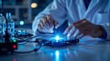 Researcher adjusting fiber-optic cables on a photonic quantum processor in a U.S. lab
