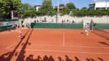 Ekaterina Alexandrova playing doubles on clay court at Roland Garros 2023, tennis match in progress