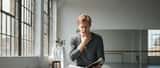 Actor rehearsing in a studio with hand on throat, voice coaching session