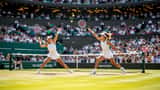 Tennis player serving on Wimbledon Centre Court grass in 2026
