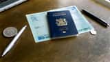 British passport and documents on a desk with sterling coins