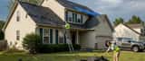 Storm-damaged suburban American home with hail damage on roof, insurance adjuster inspecting property after March 2026 megastorm