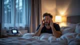 Man waking exhausted beside CPAP machine at dawn, illustrating sleep apnoea in the UK