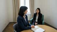 Femme française en consultation psychologique dans un cabinet parisien moderne, regard concentré, atmosphère de soin et de confiance