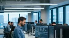Software engineer reviewing database schema diagrams on dual monitors in a San Francisco tech office