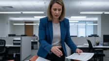 HR manager in Louisville comparing Kentucky employment law binders spread across a conference table