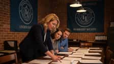 A Milwaukee employment law professional annotates Wisconsin labor law documents in a union hall meeting room
