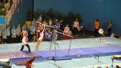 Gymnast performing on uneven bars at Commonwealth Games 2026