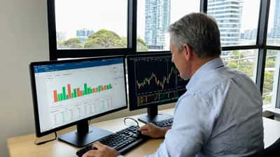 Financial adviser reviewing XRP cryptocurrency portfolio and ASIC regulatory documents in Sydney office