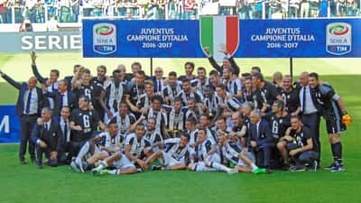 Juventus FC celebrating Serie A title, players in black and white kit on pitch