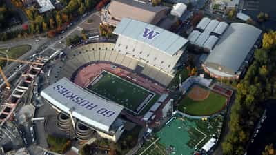 Aerial view of Husky Stadium in Seattle packed with fans during a college football game