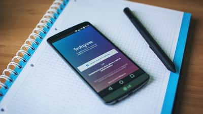 Person holding smartphone with Instagram app open