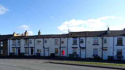 Leeds Road terraced houses in Howden Clough, Yorkshire — brick homes at risk of subsidence as summer rain returns