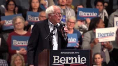 Bernie Sanders speaking at a rally addressing Social Security and retirement income protection legislation