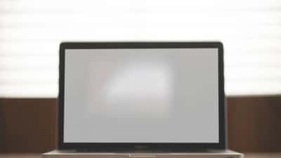 Apple MacBook laptop open on a wooden desk