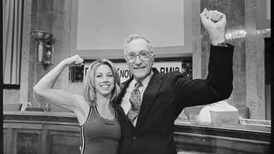 Fitness instructor Denise Austin flexing her muscles at a Shape-Up America event