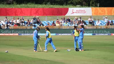 Female cricketers in action during a women's cricket match 2026