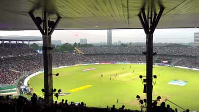 IPL cricket match at Eden Gardens stadium with fans in the stands