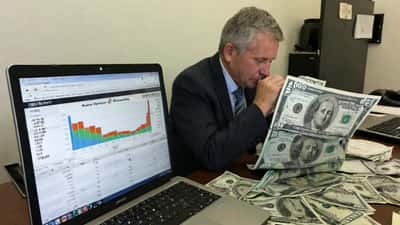 Financial adviser reviewing AUD exchange rate charts in a Sydney CBD office
