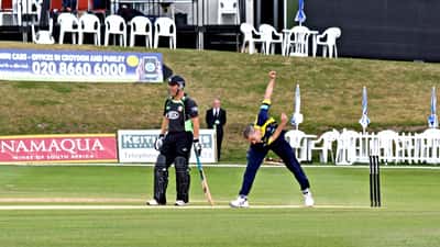Fast bowler delivering at pace during county cricket match