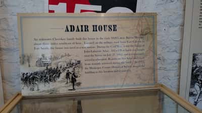 Historical exhibit display inside a National Park Service visitor center showing artifacts and informational panels