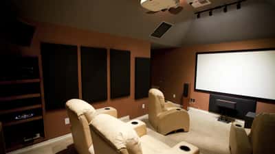 Dedicated home theatre projection room with large screen and surround sound — comparing cinema vs home setup for Dune 3 IMAX 70mm