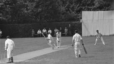 Dutch cricket players competing in a Netherlands club match at an outdoor ground