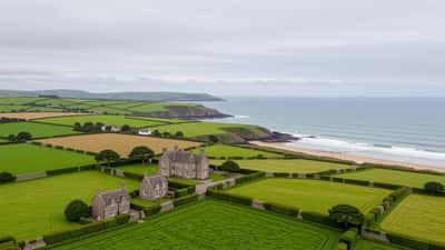 Aerial view of a large English rural estate with farmland and a manor house on the Cornwall coast