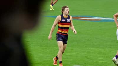 AFL players contesting the ball in an Australian rules football match at Perth Stadium