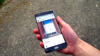 Instagram app open on a smartphone held in a hand, illustrating a service outage