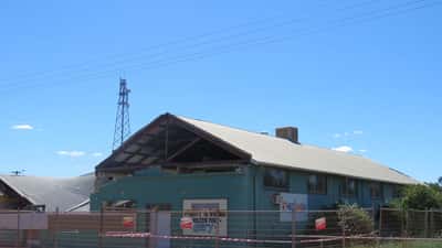 Cyclone damage to a building in Perenjori, Western Australia — roof torn and walls damaged