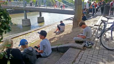 Children playing Pokémon GO outdoors on smartphones