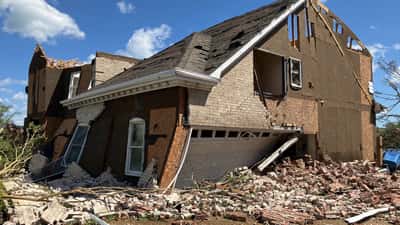EF3 tornado damage to a residential home, showing destroyed walls and debris