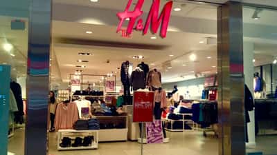 H&M store exterior showing brand signage on a busy retail street
