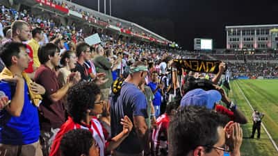 Chivas Guadalajara players competing at a U.S. stadium during an international soccer tournament