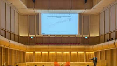 Anthropic co-founder Jack Clark presenting AI research at Oxford — wealth management perspective for Australian investors ahead of the 2026 IPO