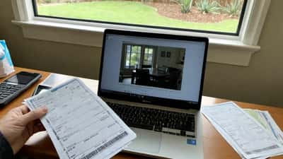 Australian consumer reviewing concert ticket purchase and hidden fees at home