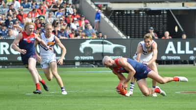 AFL players competing for a loose ball during a match